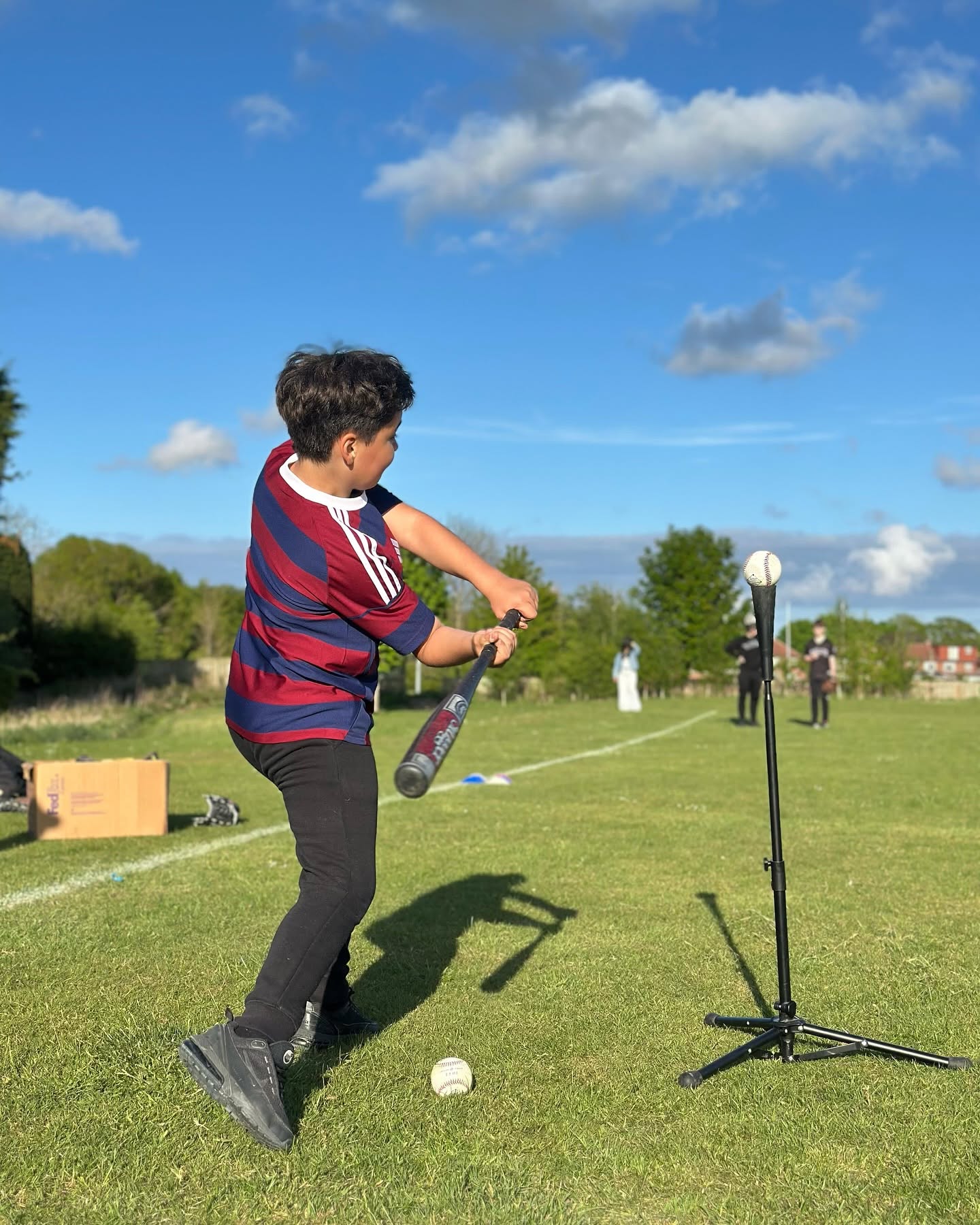 A young person taking part in a Roots for Change outdoor softball activity