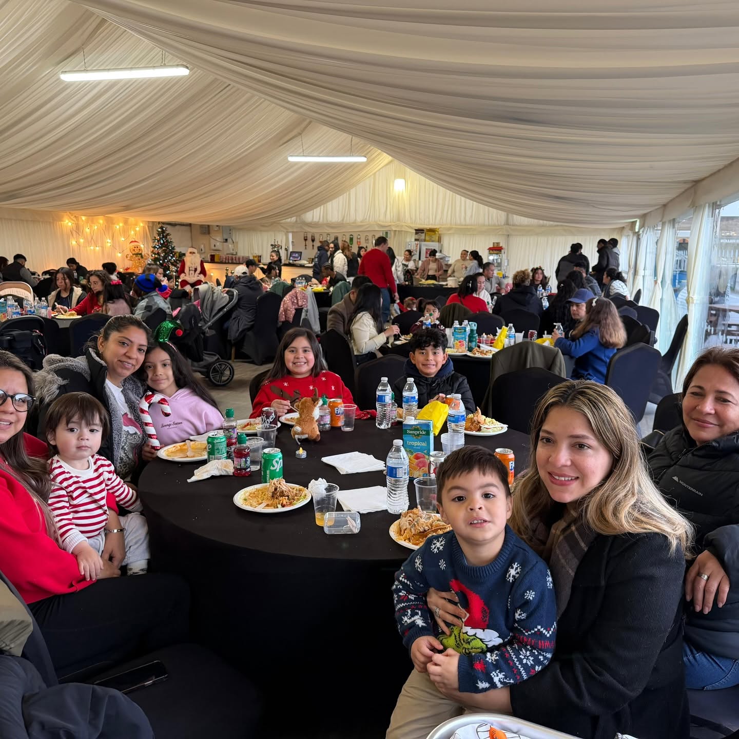 Families sharing a Christmas meal at a Roots for Change celebration