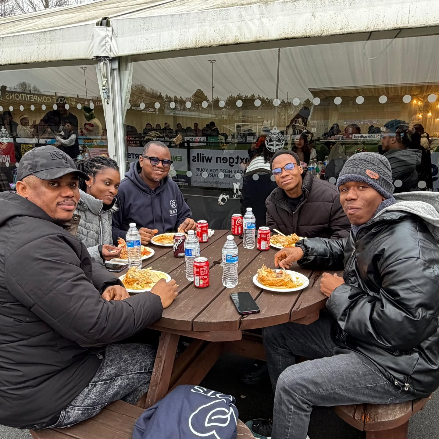 Men enjoying food together at a Roots for Change Father’s Day event