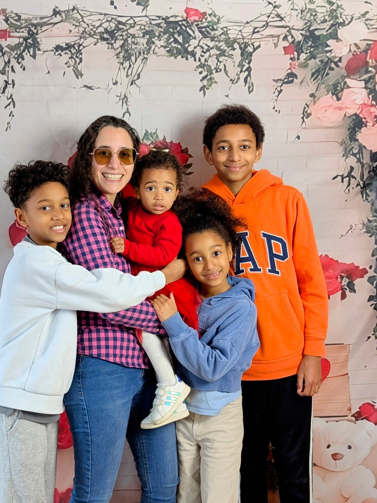 A family posing together at a Roots for Change celebration of love and friendship